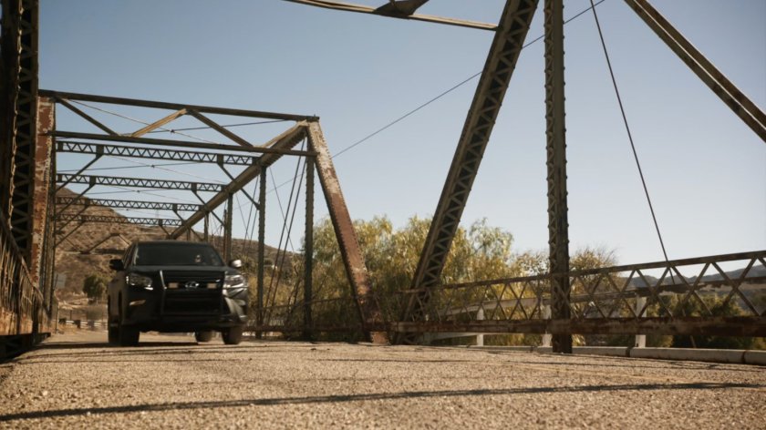 SUV drives across Bogata bridge.