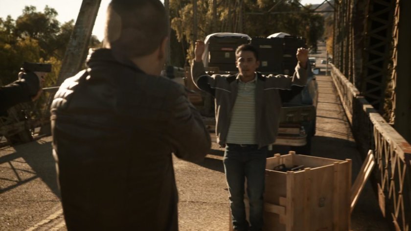 Hunter draws his gun on Francisco on a Bogota bridge.