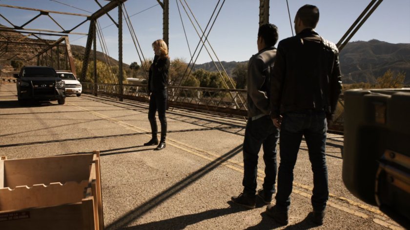 Bobbi, Hunter, and Francisco watching a police car arrive on Bogata bridge.
