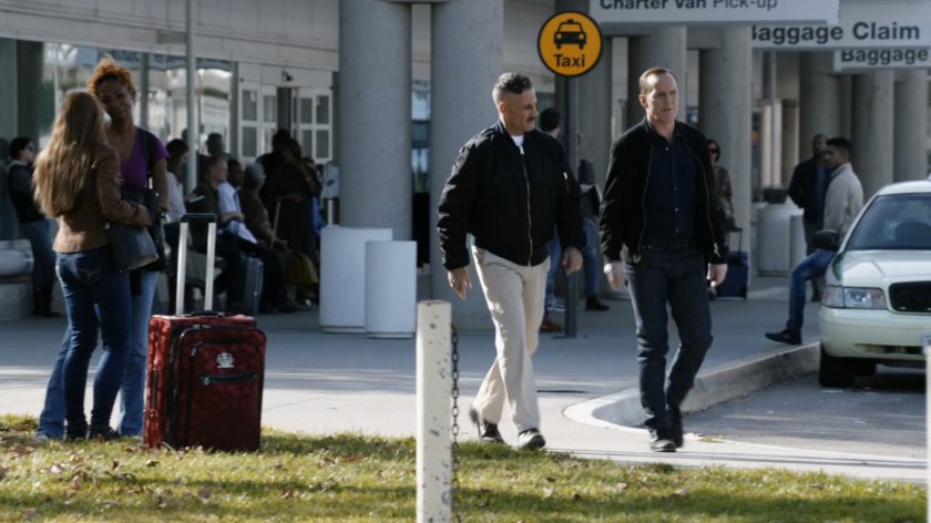 Talbot and Coulson in front of airport.