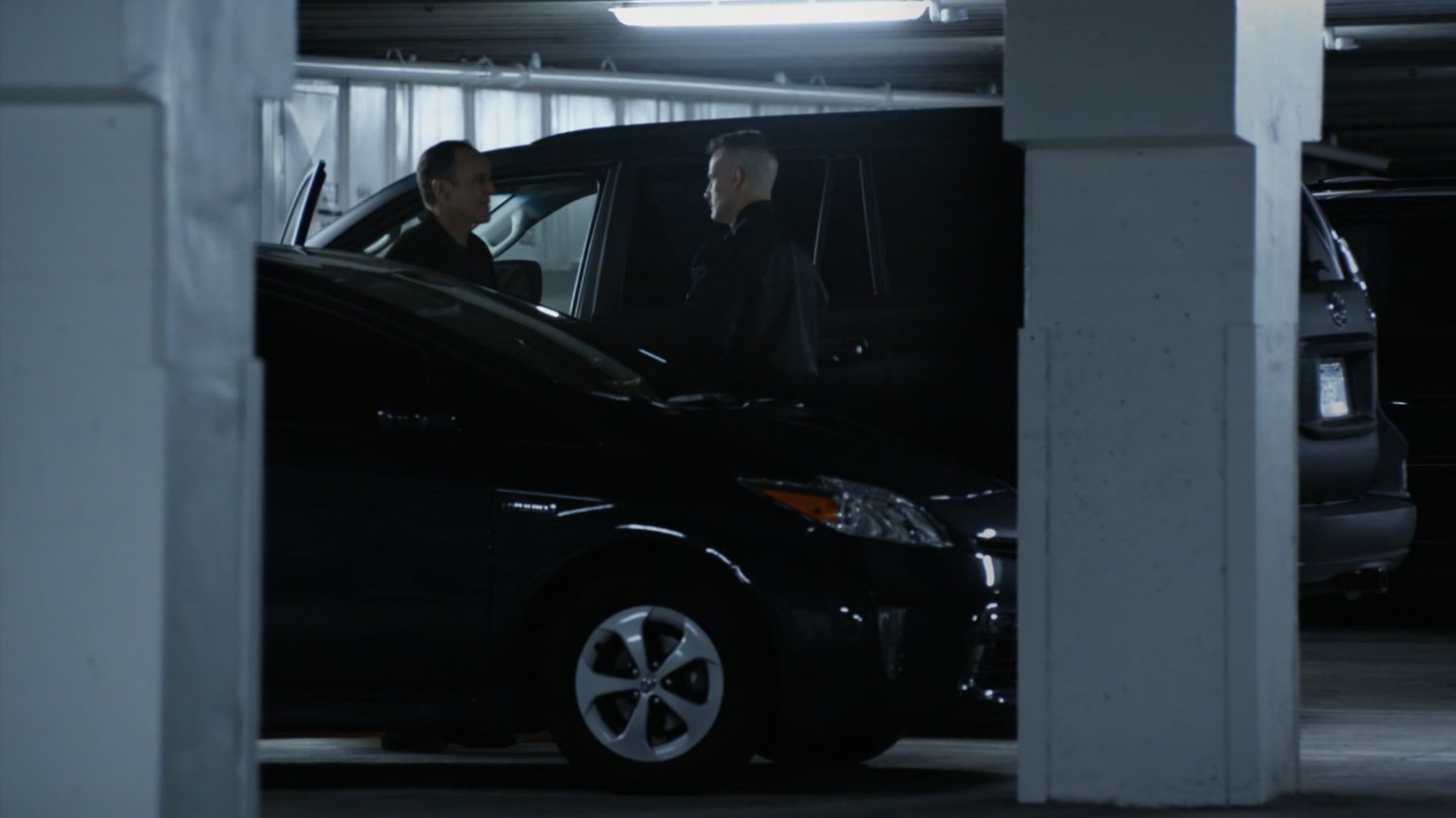 Talbot and Coulson by car in parking garage.