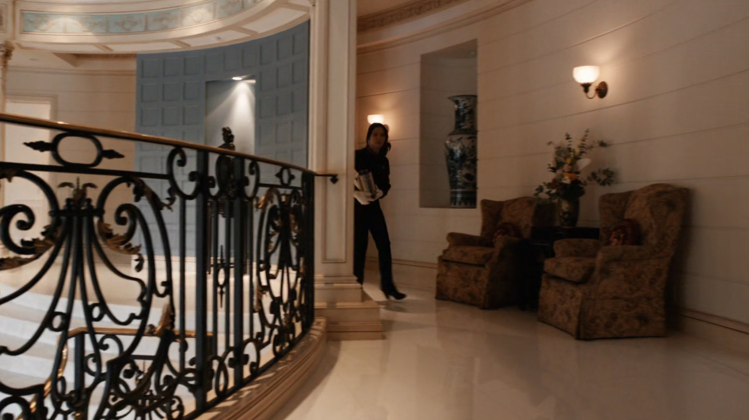 Agent May in hallway of Taiwanese mansion.