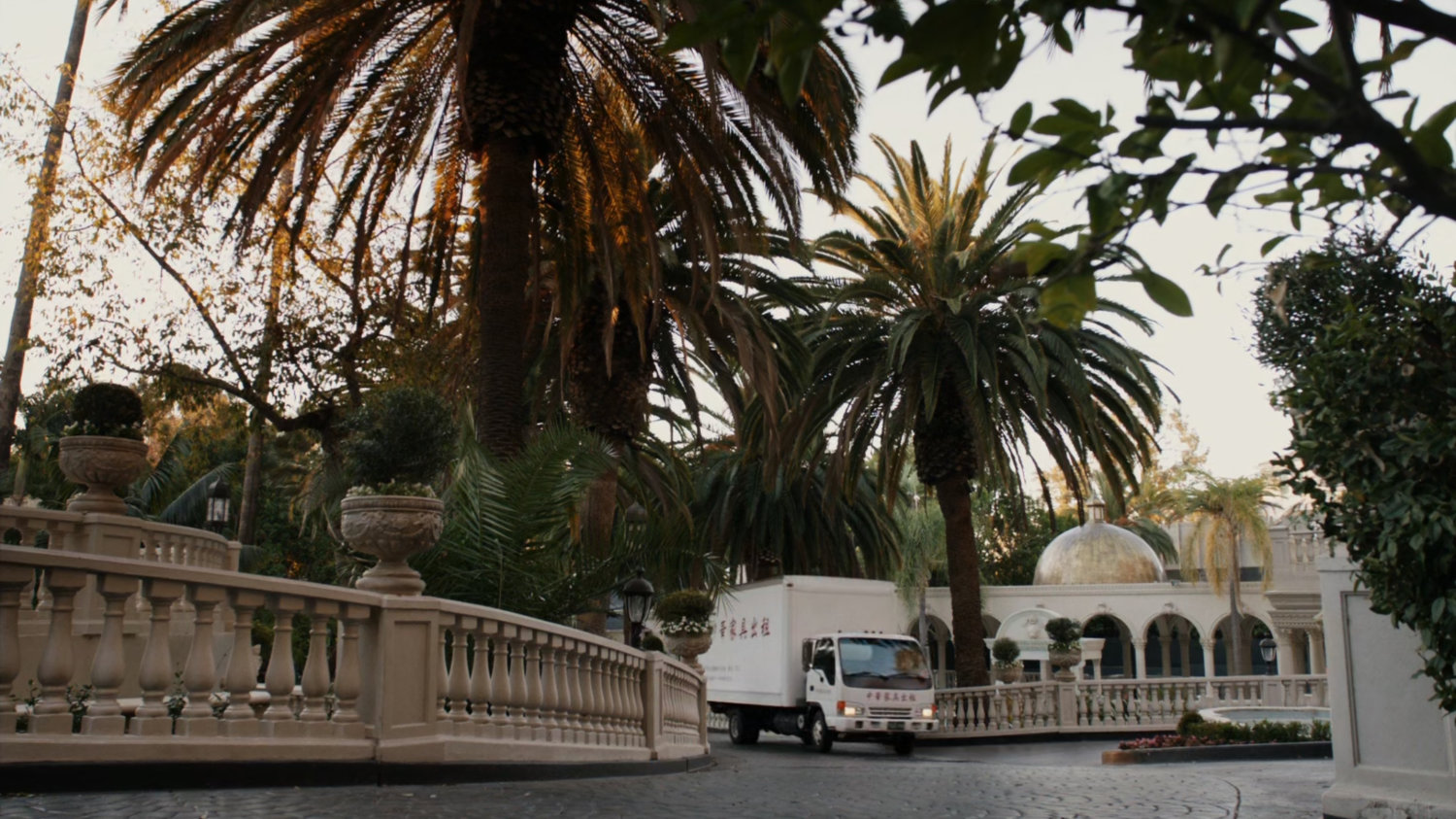 Van in front drive of Taiwanese mansion.