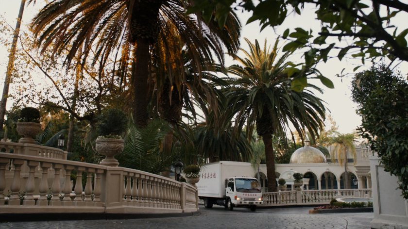 Van in front drive of Taiwanese mansion.