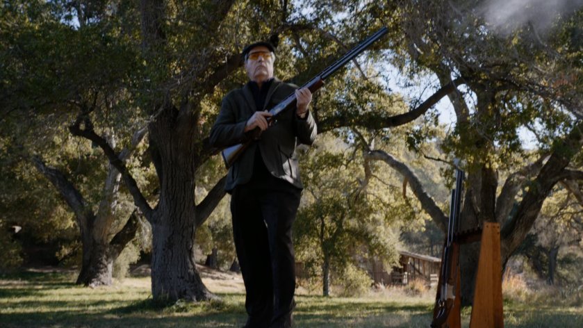 Malick shooting skeet by a lake.