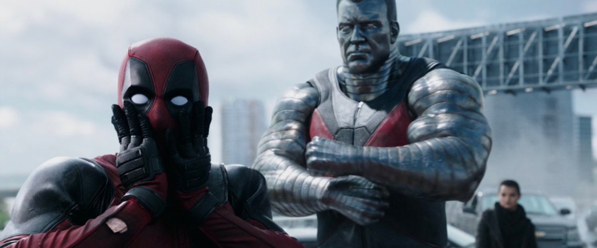 Deadpool breaking the fourth wall, with Colossus and Negasonic Teenage Warhead in the background.