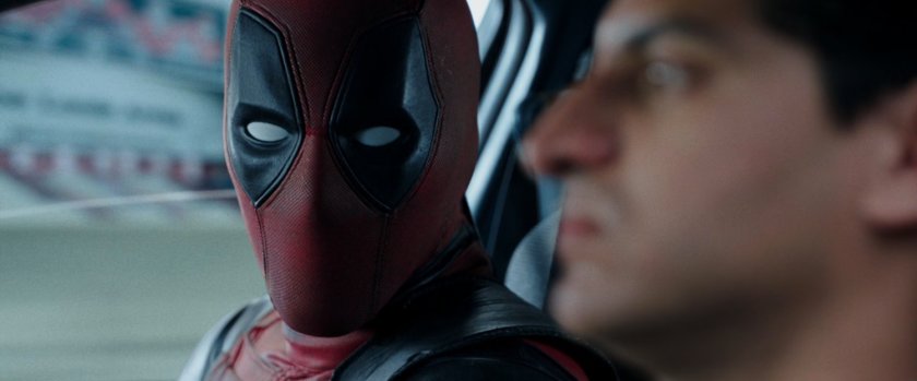 Deadpool and Dopinder in a taxi cab.