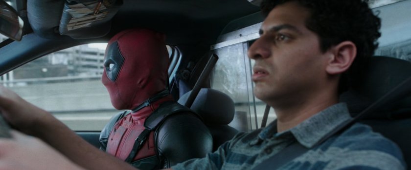 Deadpool and Dopinder in a taxi cab.