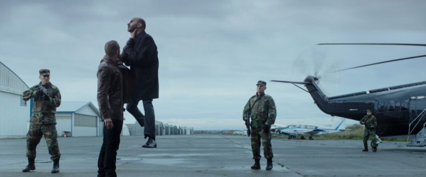Ajax choking a man on an airport tarmac, by helicopter.
