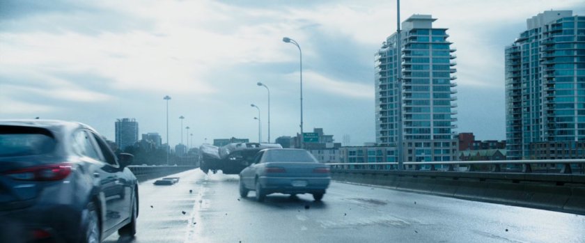 SUV crashing on freeway bridge, as other cars try to avoid it.