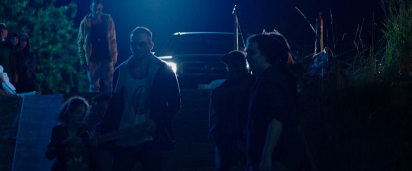 Wade Wilson walking into skate park at night.