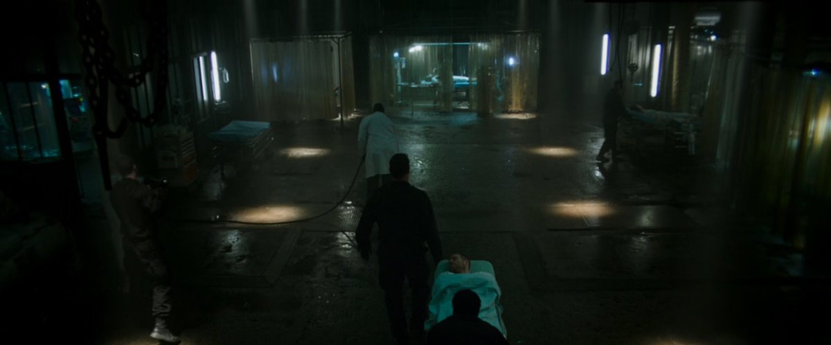 Wade wheeled into operating theater in a dingy warehouse.