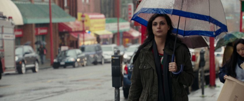 Vanessa walking on sidewalk with an umbrella.