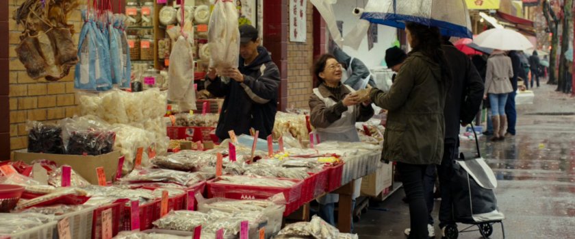 Vanessa purchasing food from vendor on sidewalk.