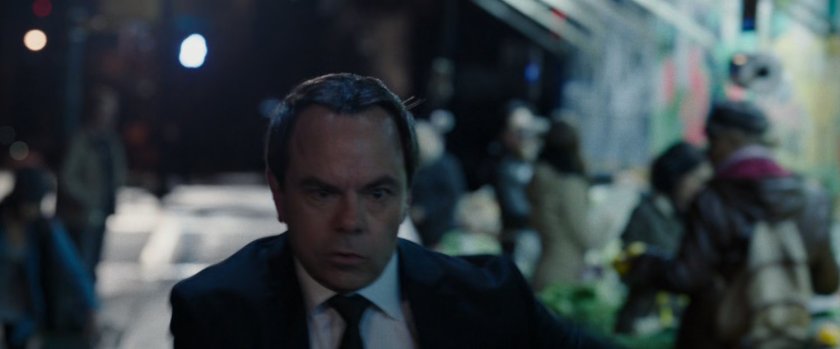 Man running on Chinatown sidewalk.