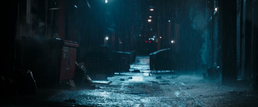 A rainy alley behind the strip club.