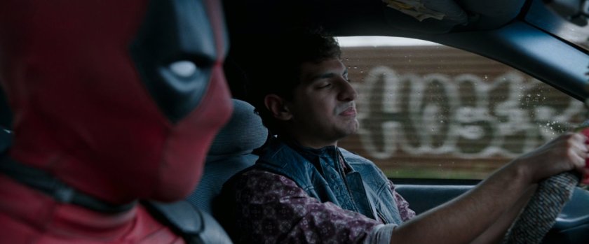 Deadpool and Dopinder in a taxi cab.