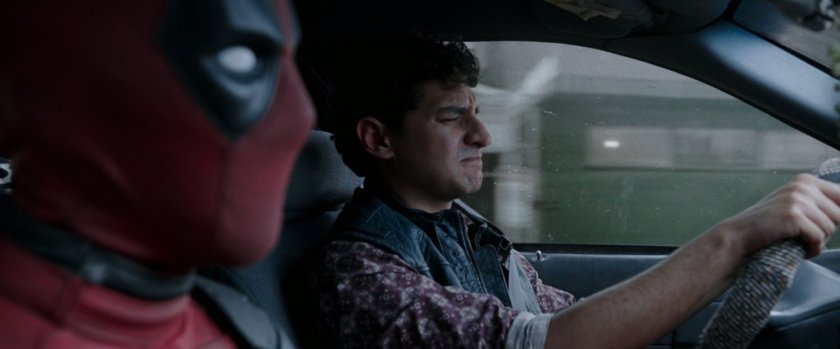 Deadpool and Dopinder in a taxi cab.