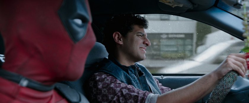 Deadpool and Dopinder in a taxi cab.