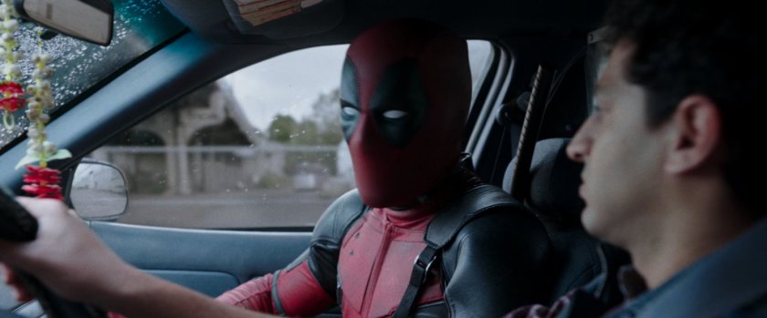 Deadpool and Dopinder in a taxi cab.