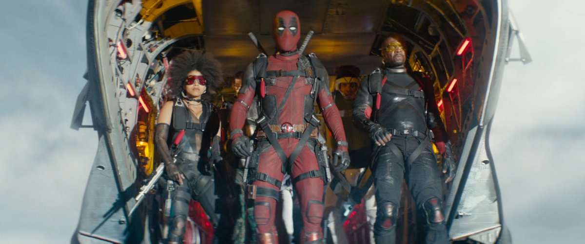 Deadpool and the members of X-Force stand in the back of a plane, ready to jump.