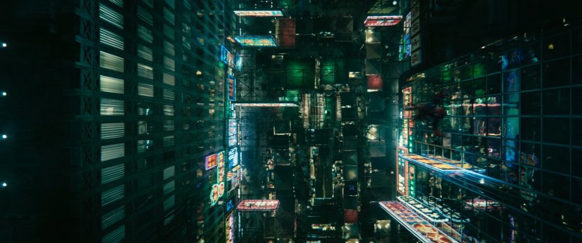 Aerial view of neon lit Hong Kong street at night.