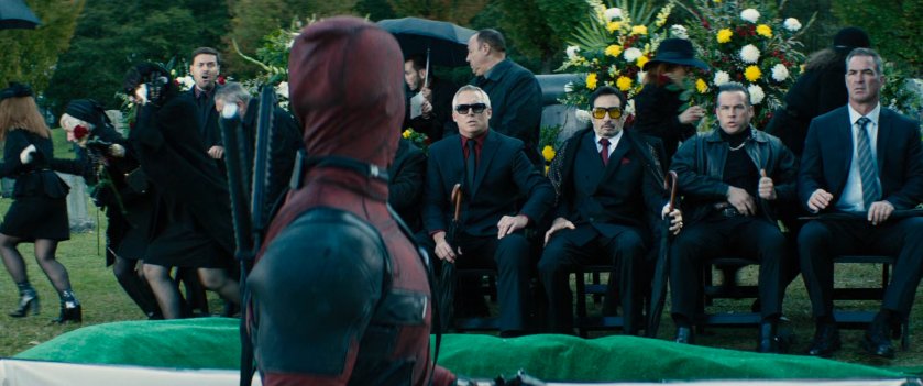 Deadpool sitting up in casket at a funeral in Sicily.