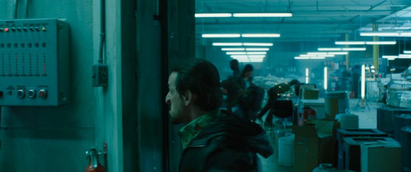 Man running into safe room at a drug warehouse.