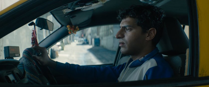 Dopinder waiting in a taxi cab.