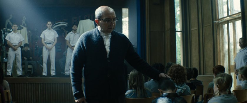 The headmaster of the Essex House addresses the children in the auditorium.