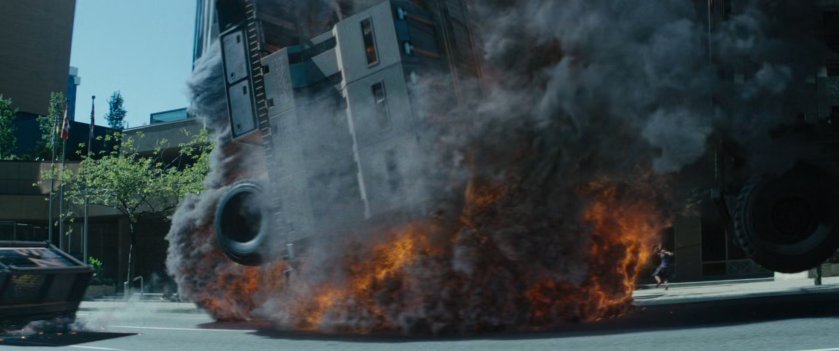 A convoy truck exploding on city street.