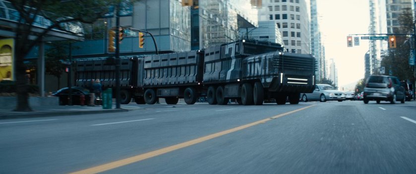 A giant prison convoy truck turning onto a city street.