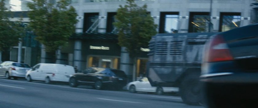 Convoy truck driving on city street.