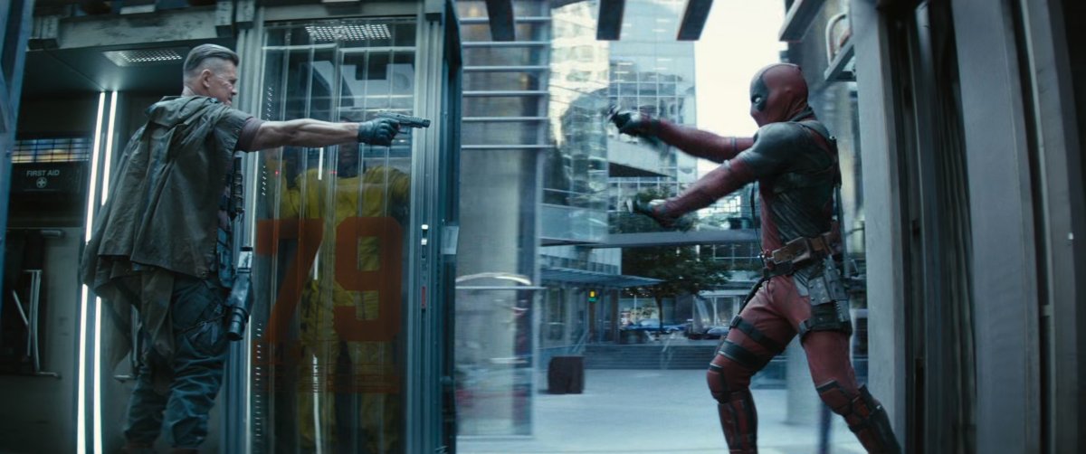 Deadpool and Cable on the back of the prison convoy truck.