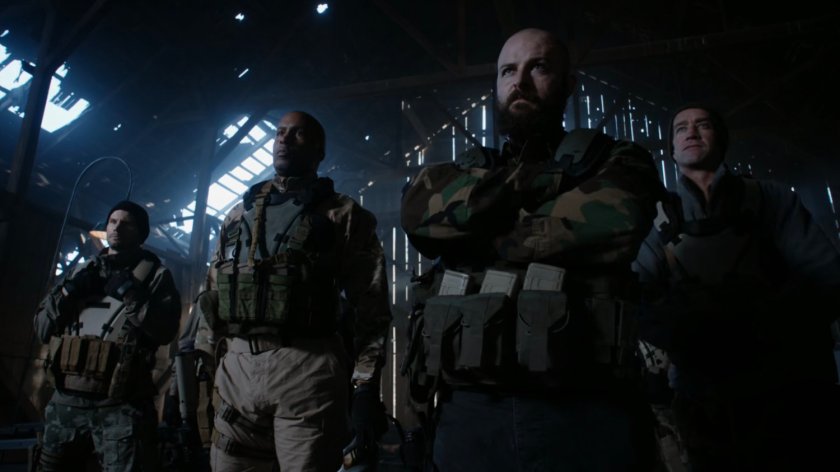 Watchdog members standing in old barn.