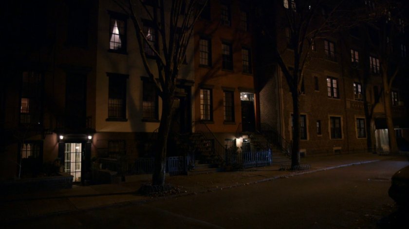 Exterior of brownstone at night.