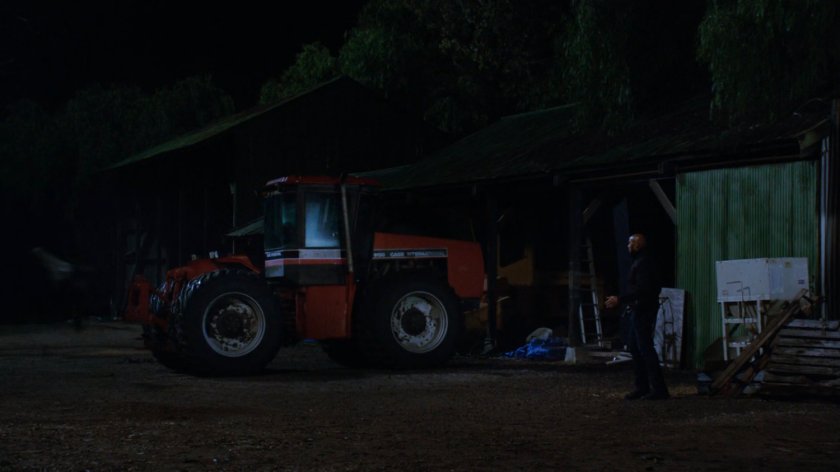 Mack standing next to a tractor outside the Watchdog barn.