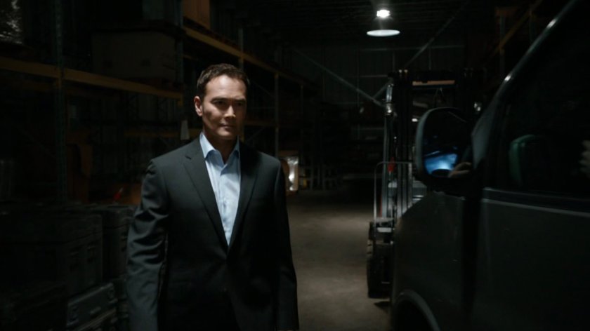 Giyera standing by van in warehouse.