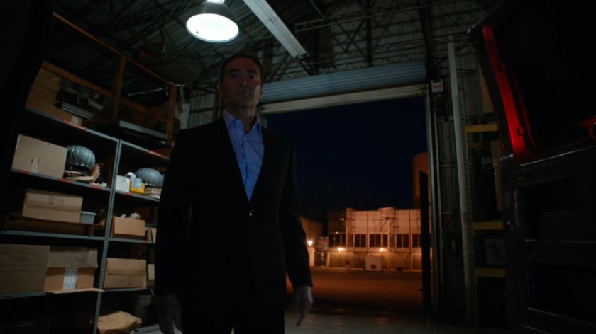 Giyera standing by van in warehouse.