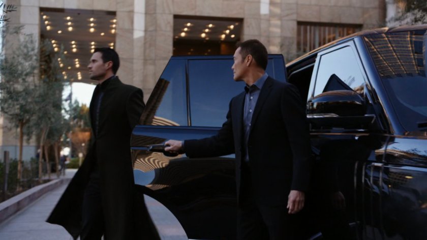 Hive and Giyera exit car outside Transia Corporation.