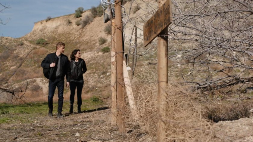 Daisy and Lincoln outside barbed wire fence in Badlands.