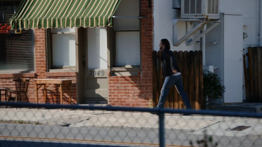 James walking drunkenly along sidewalk.