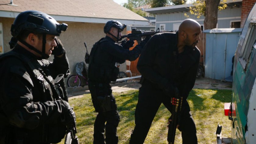 Mack and two SHIELD agents in a backyard ready to act.
