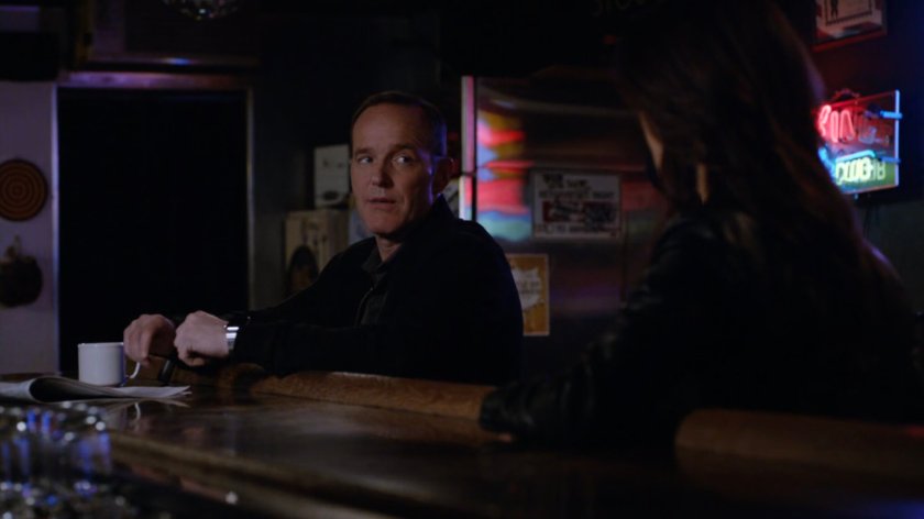 Coulson and May sitting inside a dark bar.