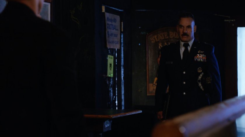 General Talbot inside a dark bar.
