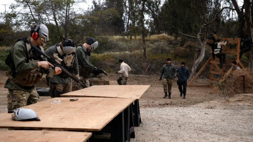 Watchdog trainees ready guns at a gun range.