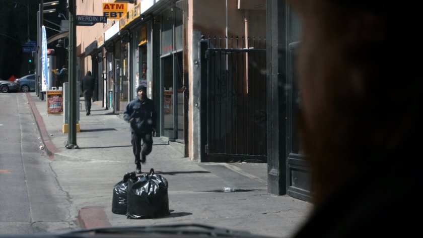 Watchdog member returns to truck along sidewalk.