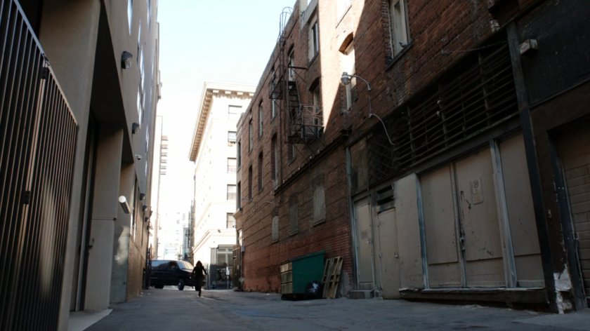 James runs into alley followed by Watchdog van.