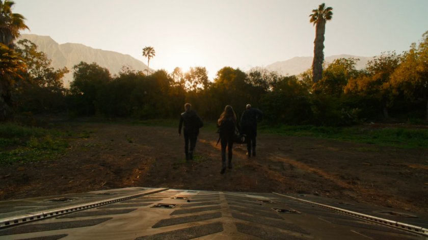 SHIELD agents depart quinjet into Pacific island clearing.