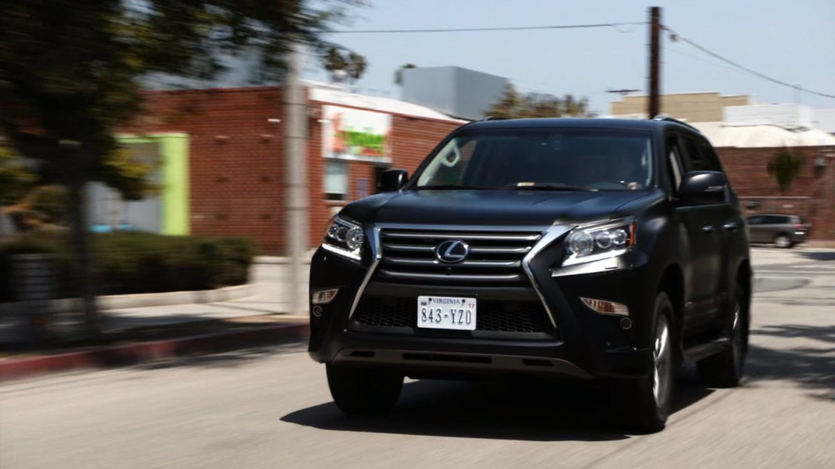 Coulson driving a SHIELD SUV along a city street.